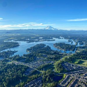View from a hot air balloon 2000 feet over Lake Tapps. The sky reflects in the water of the lake.