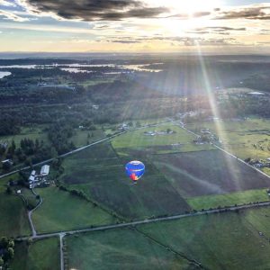 Pastel colored sunrise from a hot air balloon with views of the White River, Enumclaw, and Buckley, WA