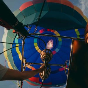 Looking up at an inflated hot air balloon envelop with hot air balloon burners on