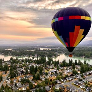 Hot air balloon flying low in the Green River at Sunrise near Seattle, WA
