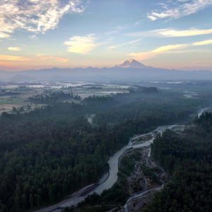 Orange, pink, and blue filled sky at sunrise. Valley views of Enumclaw. View from a hot air balloon