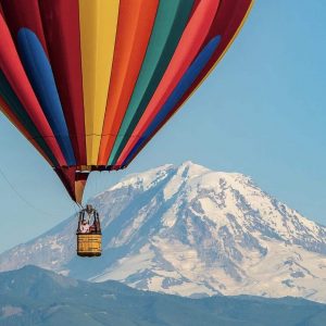 Seattle based hot air balloon directly in front of Mt. Rainier